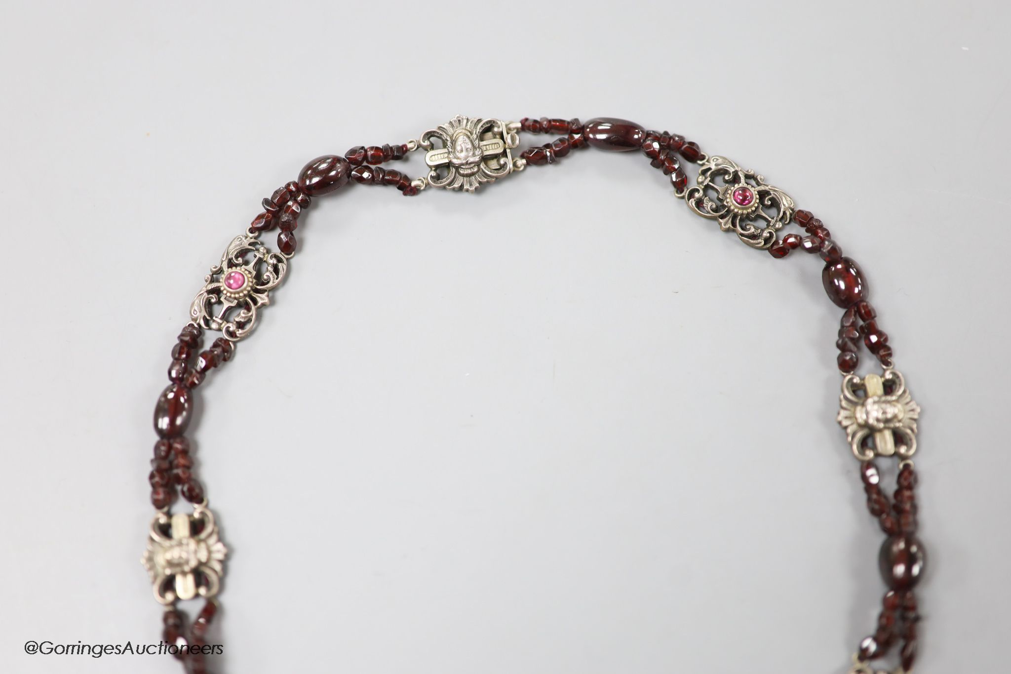 An early 20th century white metal, garnet and red paste? set choker necklace, 40cm.